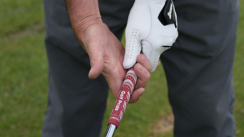 Man showing how to grip a golf club