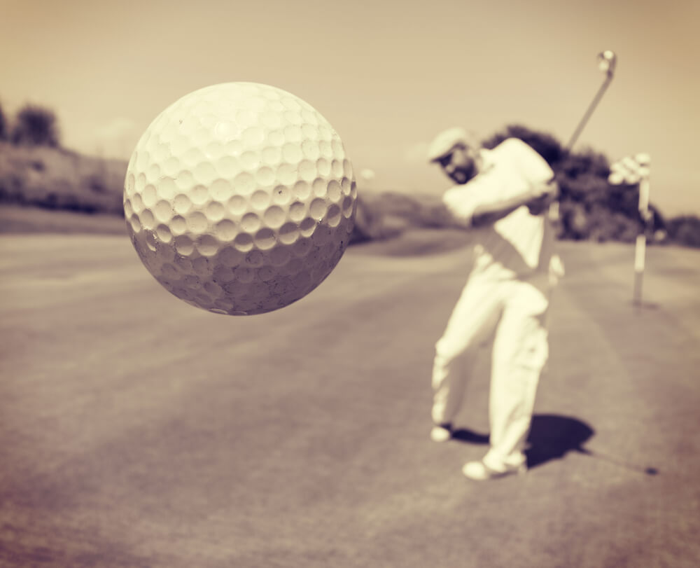 A man hit a golf ball with her full energy