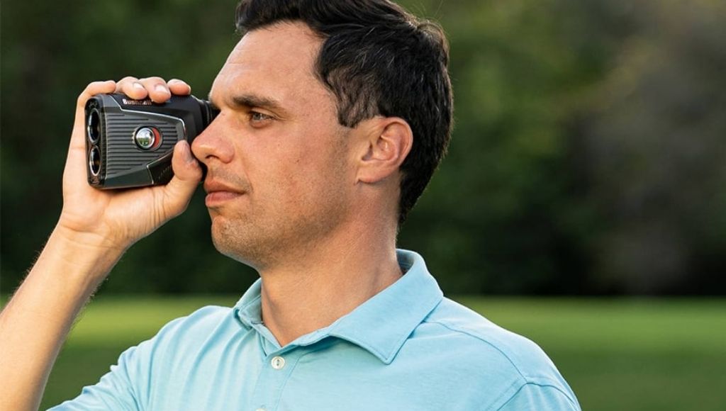 A man looking for the ball with tour v5 shift golf rangefinder