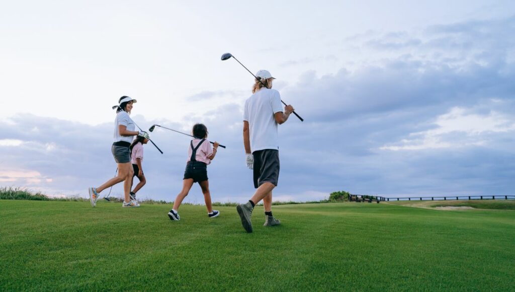A family playing a round of golf together